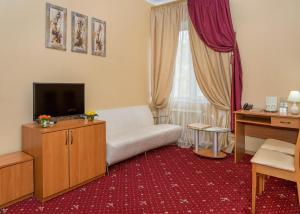 敖德萨勒尔蒙托夫斯基酒店的客厅配有白色沙发和电视