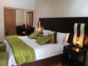 ChartwellCedar Rest Boutique Hotel的一间卧室配有一张带绿毯的大床