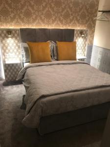 特拉利Mary Ann's Ballyheigue Cottage的卧室内的一张带橙色枕头的大床