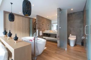 他朗Labriz Ocean Villa Plus - Tropical Modern Living的带浴缸、盥洗盆和卫生间的浴室