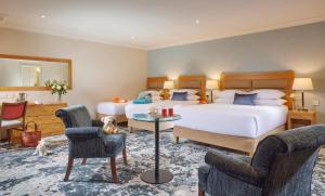 阿斯隆霍德森海湾酒店的酒店客房,配有两张床和两把椅子