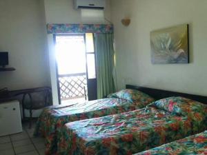 波托德索比萨维皮河口生态酒店的酒店客房设有两张床和窗户。