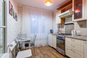 莫斯科韦奇诺布鲁斯尼卡公寓的厨房配有炉灶和桌子。