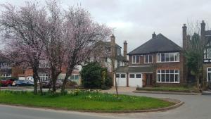 汉普顿茵雅顿Gayton Bed & Breakfast的街道前有树木和鲜花的房子