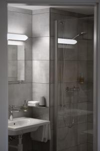 乐罗西奥伯格普雷沃克斯酒店的带淋浴和盥洗盆的浴室