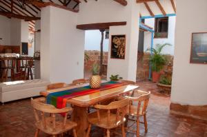 巴里查拉La Juanita Hostel Barichara的一间带木桌和椅子的用餐室