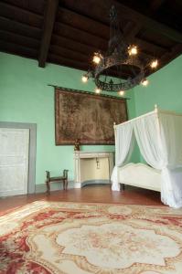 瓦尔的圣卡西亚诺伊佛迪诺别墅酒店的一间设有一张床的客房,墙上挂着一幅画