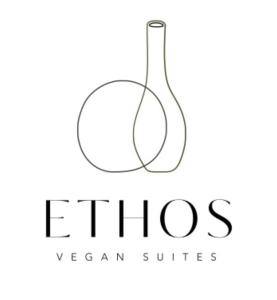 费拉Ethos Vegan Suites的葡萄酒瓶标志与葡萄酒杯