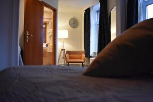法尔肯堡亚特兰大酒店的卧室配有床、椅子和窗户。