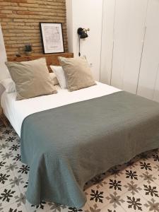 洛格罗尼奥El Secreto de Portales的卧室配有一张带白色床单和枕头的大床。