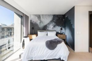 开普敦Always-Power Trendy De Waterkant Loft的一间卧室设有一张床和一个大窗户