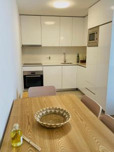 博蒂卡什Casa Sousa - 3rd generation (Apart.2)的厨房配有木桌和碗