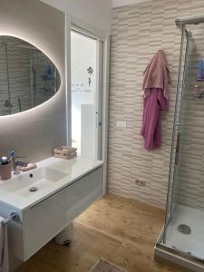 圭多尼亚Casa Molly appartamento Guidonia Tivoli terme的一间带水槽、淋浴和镜子的浴室