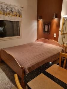 OulunsaloApartment Oulu Varjakka的一间卧室配有一张带窗户和桌子的床