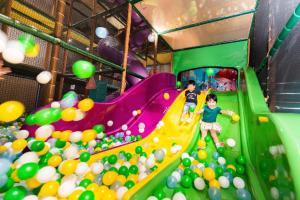台南夏都城旅安平馆的两个孩子在充满球的室内游戏室玩耍