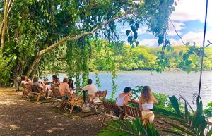 BalgueEl Pital, Chocolate Paradise的一群坐在湖畔桌子上的人