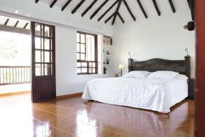 亚美尼亚Hotel Chalet El Castillo by Majuva的白色卧室配有一张带白色床单的大床