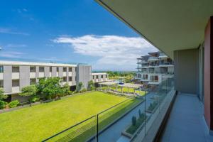 SibayaUnit 215 Oceandune - Stunning & Modern Apartment的从带草坪的建筑的阳台上可欣赏到风景