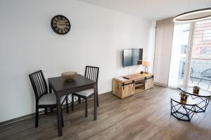 德累斯顿Stylisches Apartment im Herzen von Dresden + Parkplatz + Netflix + Self Check-in的一间带桌椅和电视的用餐室