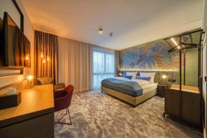 波恩NYCE Hotel Bonn的配有一张床和一张书桌的酒店客房