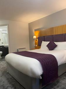 普雷斯顿Purple Roomz Preston South的酒店客房设有一张大床和一间浴室。