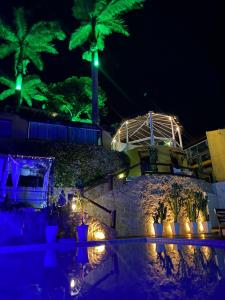 布希奥斯Bliss Hotéis Bella Vista的棕榈树和灯光的度假村的夜景