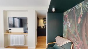 布鲁塞尔Suite lumineuse à Saint-Gilles的客厅设有绿色的墙壁和沙发。