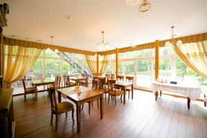 拉克韦雷特里萨别墅酒店​​的用餐室设有桌椅和窗户。