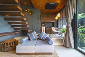 拉扬海滩度AKRA Collection Layan的带沙发和楼梯的客厅