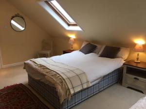 安德沃Chalkcroft lodge的一间卧室配有一张床、两盏灯和一个窗户。