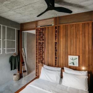 曼谷Tamni的一间卧室配有一张木墙床