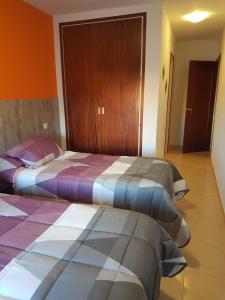 菲格拉斯Hostal Galicia的两张睡床彼此相邻,位于一个房间里