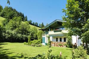 伊特尔holiday home, Itter的一座带绿色庭院的山丘上的房子