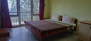 Kumaragiri Cottages Kodaikanal客房内的一张或多张床位