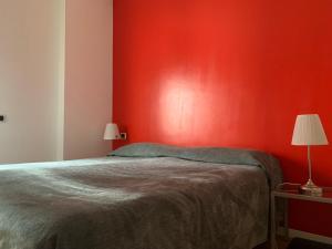 米兰Moscova Design Home的红色的卧室,配有一张床和红色的墙壁