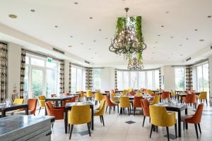 皇家滕布里奇韦尔斯SPA酒店的一间带桌椅和吊灯的用餐室