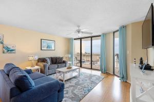 富丽海滩301 Charleston Oceanfront Villas的客厅配有2张蓝色的沙发和1张沙发