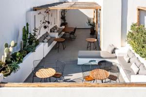 费拉Lemon Suites Santorini的大楼内带桌椅的庭院