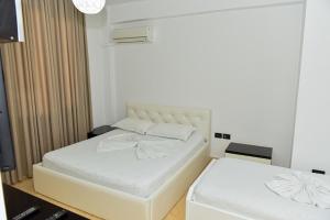 GramshHotel Tomorri的卧室配有白色的床和白色床垫。