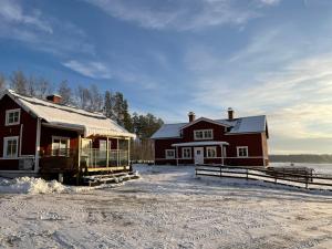 博伦厄Backes Lillstuga的雪地里的谷仓和房子