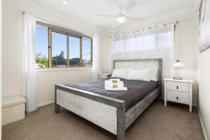 金斯克里福Hungerford Beach Apartment by Kingscliff Accommodation的一间卧室设有一张大床和一个窗户。
