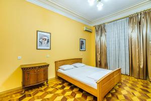 巴库Targovu Nizami Street 4 room的黄色的卧室设有床和窗户