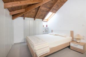 AsfendioúPanoramiKos的一间卧室设有一张大床和木制天花板。