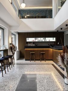 雅典NLH KERAMEIKOS - Neighborhood Lifestyle Hotels的餐厅设有酒吧,配有桌椅