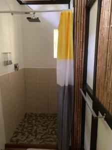 蓬塔乌巴Pequeño Paraiso 1的浴室里配有带色彩缤纷的淋浴帘的淋浴