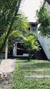 米瑞莎Kiara Sands的一座房子,拥有棕榈树和楼梯