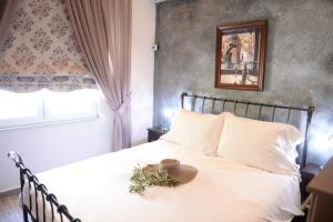 帕莱欧卡斯提撒angela panorama的卧室配有白色的床和帽子