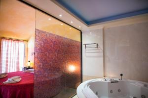 雅典Anastazia Luxury Suites & Spa的带浴缸和红色淋浴的浴室