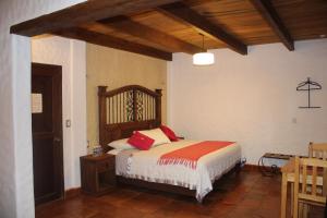 圣克里斯托瓦尔-德拉斯卡萨斯Hotel Na´Lum的一间卧室配有一张带红色枕头的床