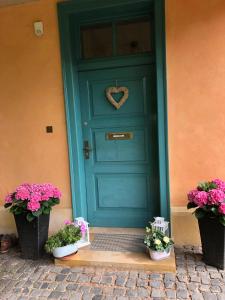 艾森纳赫Ferienhaus Eisenach的蓝色的门,上面有心花环